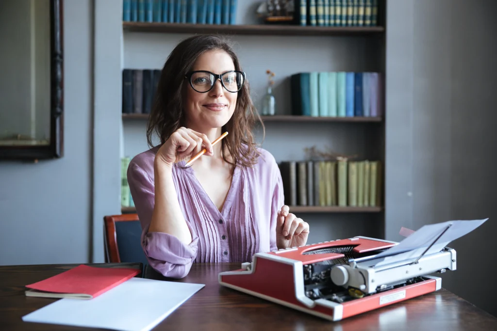 portrait-mature-smiling-authoress-sitting-desk